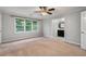 A bedroom with neutral walls, carpet, and a window offering natural light and outdoor views at 1378 Sheffield Glen Ne Way, Atlanta, GA 30329