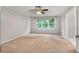A bedroom with neutral walls, carpet, and a window offering natural light and outdoor views at 1378 Sheffield Glen Ne Way, Atlanta, GA 30329