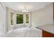 Bright breakfast nook with tile floor and windows offering views of lush greenery at 1378 Sheffield Glen Ne Way, Atlanta, GA 30329