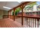 A wooden deck with a railing offers an outdoor living space with a view of the surrounding foliage at 1378 Sheffield Glen Ne Way, Atlanta, GA 30329