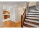 Inviting entryway featuring a wooden staircase and hardwood floors leading to the kitchen at 1378 Sheffield Glen Ne Way, Atlanta, GA 30329