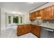 Features a kitchen with wood cabinets, granite countertops, stainless steel appliances and tile flooring at 1378 Sheffield Glen Ne Way, Atlanta, GA 30329