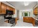 The kitchen showcases stainless steel appliances, wood cabinets, tile flooring and a sunny breakfast nook at 1378 Sheffield Glen Ne Way, Atlanta, GA 30329