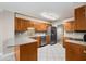 A well-lit kitchen with wood cabinets, granite countertops, stainless steel appliances and tile flooring at 1378 Sheffield Glen Ne Way, Atlanta, GA 30329