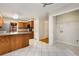 A spacious kitchen with wood cabinets, granite countertops and an adjacent laundry room at 1378 Sheffield Glen Ne Way, Atlanta, GA 30329