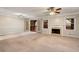 Spacious living room with plush carpet, a fireplace, and access to the back deck at 1378 Sheffield Glen Ne Way, Atlanta, GA 30329