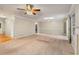 Bright living room featuring neutral carpet, a ceiling fan, and a fireplace at 1378 Sheffield Glen Ne Way, Atlanta, GA 30329