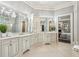 Large bathroom with white cabinets, double vanity, and large framed mirrors at 145 Ardsley Ln, Alpharetta, GA 30005