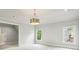 Well-lit bedroom with light walls, two windows, and a modern light fixture at 145 Ardsley Ln, Alpharetta, GA 30005