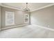Bright, neutral bedroom featuring carpeted floors and two windows for natural light at 145 Ardsley Ln, Alpharetta, GA 30005