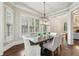 Bright dining room with modern chandelier, large windows, and comfortable seating for dinner at 145 Ardsley Ln, Alpharetta, GA 30005