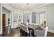 Formal dining room featuring hardwood floors, elegant chandelier, and classic architectural details at 145 Ardsley Ln, Alpharetta, GA 30005