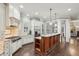 Well-appointed kitchen featuring stainless steel appliances, custom cabinets, and granite countertops at 145 Ardsley Ln, Alpharetta, GA 30005
