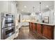 Gourmet kitchen with double ovens, island with breakfast bar, and abundant cabinet space at 145 Ardsley Ln, Alpharetta, GA 30005