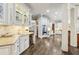 Bright eat-in kitchen features granite counters, pendant lighting, and stainless appliances at 145 Ardsley Ln, Alpharetta, GA 30005