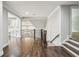 Bright landing space with hardwood floors, iron railings, and natural light at 145 Ardsley Ln, Alpharetta, GA 30005