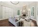 Cozy living room with a stone fireplace, built-in cabinets, and comfortable seating at 145 Ardsley Ln, Alpharetta, GA 30005
