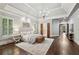 Spacious main bedroom boasts dark hardwood floors, tray ceiling, and light gray walls at 145 Ardsley Ln, Alpharetta, GA 30005