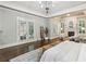 Spacious main bedroom boasts dark hardwood floors, a fireplace, and light gray walls at 145 Ardsley Ln, Alpharetta, GA 30005