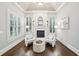 Main bedroom sitting area features a fireplace, light gray walls, and large windows at 145 Ardsley Ln, Alpharetta, GA 30005