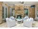Cozy outdoor space featuring a brick fireplace and comfortable seating at 145 Ardsley Ln, Alpharetta, GA 30005
