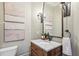 Charming powder room features rustic wood vanity and unique artwork at 145 Ardsley Ln, Alpharetta, GA 30005