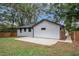 Newly renovated home with a spacious backyard, black gutters, and wood fence at 1934 Pinedale Pl, Decatur, GA 30032
