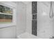 Tiled bathtub and shower combination with a modern black tile accent niche and window at 1934 Pinedale Pl, Decatur, GA 30032