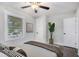 Cozy bedroom featuring hardwood floors, neutral tones, large window, and ceiling fan at 1934 Pinedale Pl, Decatur, GA 30032