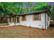 Charming home with painted brick, new walkway, updated landscaping, wooden shutters and a welcoming entrance at 1934 Pinedale Pl, Decatur, GA 30032