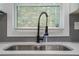 Kitchen sink with quartz countertops, a black faucet, and a view from the window at 1934 Pinedale Pl, Decatur, GA 30032