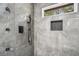 Elegant shower featuring gray marble-look tile, a window and black fixtures at 1934 Pinedale Pl, Decatur, GA 30032