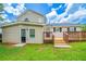 Exterior view of the backyard with a wooden deck and a well-manicured lawn at 2183 Ramblewood Cir, Decatur, GA 30035