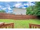 Large fenced backyard with green lawn, perfect for outdoor activities and relaxation at 2183 Ramblewood Cir, Decatur, GA 30035