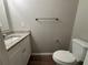 Updated powder room with granite countertop, white vanity, and modern fixtures at 2183 Ramblewood Cir, Decatur, GA 30035