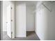 Walk-in closet with an open door and metal hanging racks, providing ample storage space at 2183 Ramblewood Cir, Decatur, GA 30035