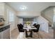 Dining room featuring modern table set atop white rug next to stairwell and open floorplan at 2183 Ramblewood Cir, Decatur, GA 30035