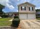Two story home with two car garage, red door, and manicured lawn at 2183 Ramblewood Cir, Decatur, GA 30035