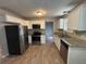 Updated kitchen with stainless steel appliances, granite countertops, and wood-look flooring at 2183 Ramblewood Cir, Decatur, GA 30035