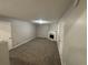 Cozy living room with plush carpeting, fireplace and mantle, and neutral paint at 2183 Ramblewood Cir, Decatur, GA 30035