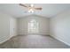Spacious main bedroom featuring carpeted floor, ceiling fan and a window with natural light at 2183 Ramblewood Cir, Decatur, GA 30035