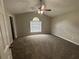 Spacious main bedroom featuring high ceilings, a ceiling fan, and plush carpeting at 2183 Ramblewood Cir, Decatur, GA 30035