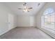 Bright main bedroom with a ceiling fan, large window, and two doors for added convenience at 2183 Ramblewood Cir, Decatur, GA 30035