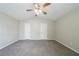 Spacious main bedroom featuring carpeted floor, ceiling fan and two doors for added convenience at 2183 Ramblewood Cir, Decatur, GA 30035