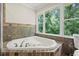 Bathroom with jacuzzi tub and window overlooking wooded scenery at 3120 Beechwood Se Dr, Marietta, GA 30067