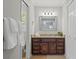 Bathroom with a single sink vanity, granite counters and a large framed mirror at 3120 Beechwood Se Dr, Marietta, GA 30067
