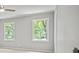 Bright bedroom with two windows, ceiling fan, and neutral gray paint at 3120 Beechwood Se Dr, Marietta, GA 30067