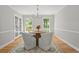Bright dining room with chandelier, wood table, and chairs overlooking the front yard at 3120 Beechwood Se Dr, Marietta, GA 30067