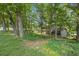 View of house, nestled among mature trees, with visible shed at 3120 Beechwood Se Dr, Marietta, GA 30067