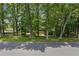 View of the house from across the street, framed by mature trees at 3120 Beechwood Se Dr, Marietta, GA 30067